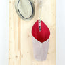 portaoggetti appeso rosso e bianco realizzato in vele riciclate da rivelami